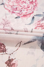 Pink floral halter neck maxi dress with crisscross back and wide-brim hat