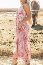 Pink floral halter neck maxi dress with crisscross back and ruffled hem
