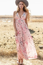 Pink floral print halter neck maxi dress with V-neckline and crisscross back