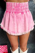Pink frayed denim shorts with wide smocked waistband and raw hem