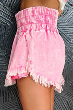 Pink frayed denim shorts with wide smocked waistband and raw hem