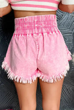 Pink frayed denim shorts with wide smocked waistband and raw hem