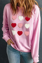 Light pink long sleeve sweatshirt with contrast heart patches