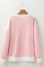 Pink ribbed girls sweater with heart patch, white trim, round neckline