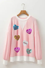 Pink striped girls sweater with heart patches and white trim