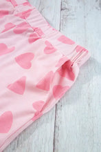 Pink heart-print fleece shorts with elastic waistband and drawstring length