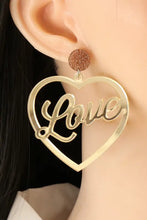 Gold heart shape acrylic dangle earrings with love script and glitter accent