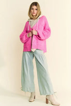 Pink long sleeve cardigan with hood, textured sleeves, and drawstring hem