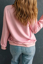 Person in pink dropped shoulder sweatshirt, long sleeve, blue jeans
