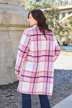 Pink plaid wool lapel collar coat with button closure, pockets, and long sleeve length