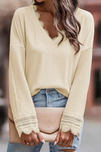 Pink ribbed v neck sweater with lace trim and distressed denim jeans