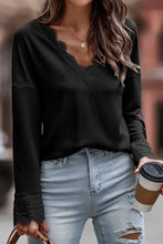 Pink ribbed V neck sweater with lace trim and distressed jeans