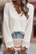 Pink ribbed v neck sweater with white lace trim and long sleeves