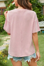 Pink striped corduroy pocket tee with ribbed short sleeves and round neck