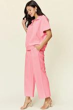 Pink zip short sleeve collared shirt and wide leg cropped pants set