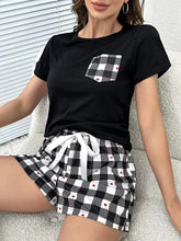 Black short-sleeved top with black-and-white checkered pocket with red hearts in plaid heart lounge set designed to tumble dry