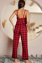 Red and black plaid pajama jumpsuit with thin spaghetti strap length and ruffled waistband for comfortable wear