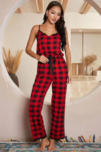 Red and black plaid pajama jumpsuit with scalloped neckline and adjustable strap length featuring a drawstring waist