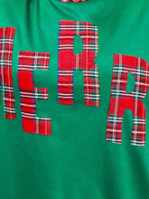 Green round neck sweatshirt with bold red plaid merry lettering, machine wash cold for easy care