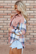 Plaid pink and white jacket with denim shorts on brick wall