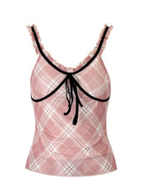 Pink plaid ruffle trim cami with black ruffled straps and matching bow at the neckline for stylish layering