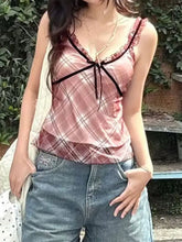 Pink satin plaid ruffle trim cami with black lace trim and bow at neckline for elegant layering