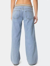 Light-wash denim wide leg jeans featuring a plaid trim waistband in plaid trim wide style for a modern look