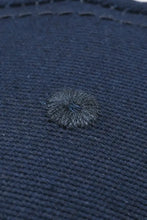 Dark blue textured cotton baseball cap with fluffy hair tuft