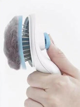 White and blue slicker brush with soft fuzzy head removes loose fur