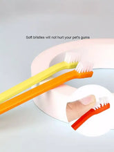 Plastic pet toothbrush with soft white bristles, yellow and orange handles