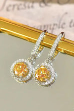 Platinum-plated 2 carat moissanite drop earrings feature yellow stones with white halo