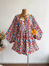 Plus size boho floral print romper in white with vibrant red, blue, purple paisley motifs