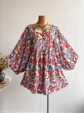 Plus size boho floral print button-down romper with vibrant paisley pattern