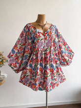 Plus size boho floral print button-down romper with vibrant paisley pattern
