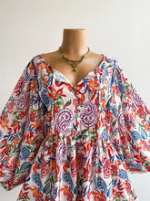 Plus size boho floral print button-down romper with vibrant paisley pattern