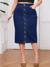 Plus size dark blue denim skirt with front button closure, side pockets, high waist, and slightly stretchy fabric