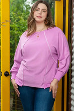 Plus size woman in contrast stitching long sleeve lavender T-shirt and jeans