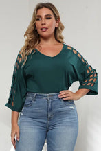 Plus size dark teal V-neck top with lattice sleeve cutout