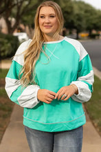 Plus size exposed seam color block teal and white raglan sweatshirt