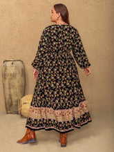 Plus size floral balloon sleeve maxi dress with black print and tiered hem