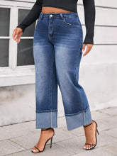 Plus size high waist wide leg jeans in blue denim with rolled cuffs offering a stylish and comfortable fit