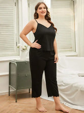 Plus size black satin camisole and pants pajama set with lace trim at the hem for comfortable nightwear