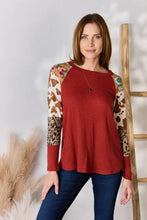 Plus size leopard waffle-knit blouse with red textured animal print sleeves