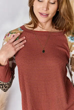 Plus size leopard waffle-knit blouse with floral sleeves and animal print cuffs