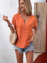 Plus size notched short sleeve cream button-up blouse with frayed denim shorts