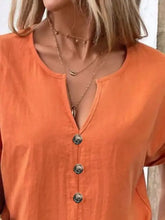 Plus size notched short sleeve cream button-up top with deep V-neck and layered necklaces