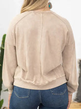 Plus size peace sign long sleeve sweatshirt on woman in jeans