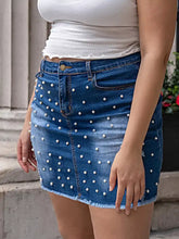 Plus size pearl embellished blue denim skirt with white pearl studs and frayed hem in a mini cut