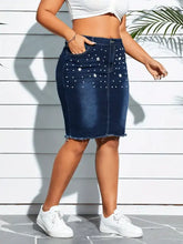 Dark blue denim skirt with pearl embellished frayed hem and white floral details for plus size wear