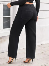 Plus size black denim wide leg jeans with pearl embellished wide leg button accents on outer seams